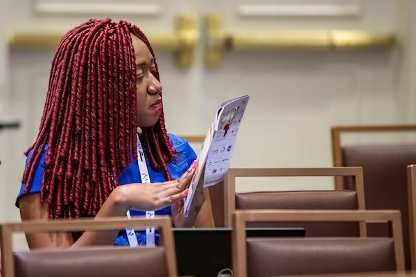 Attendee reading the conference program
