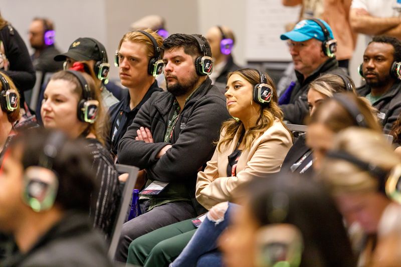 Attendees in wireless headphones listening to a session