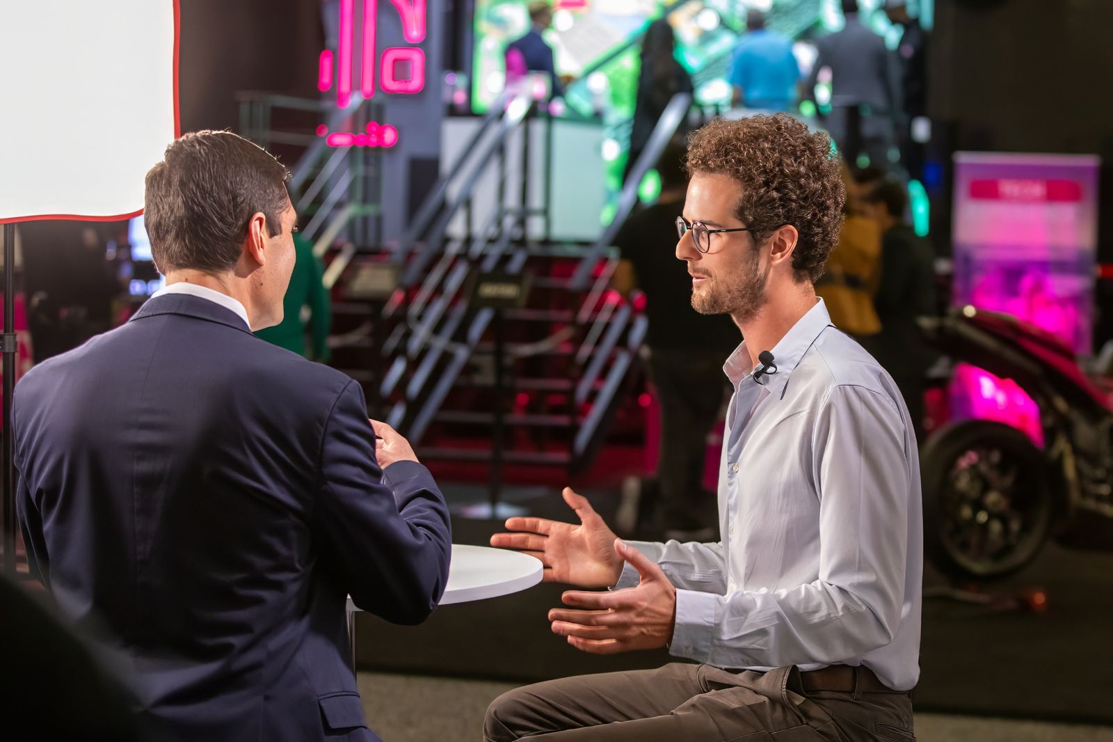 Two people in conversation at a trade-show booth