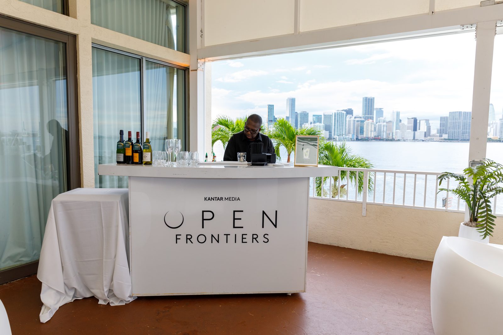 Branded bar on a balcony overlooking Biscayne Bay and the Miami skyline
