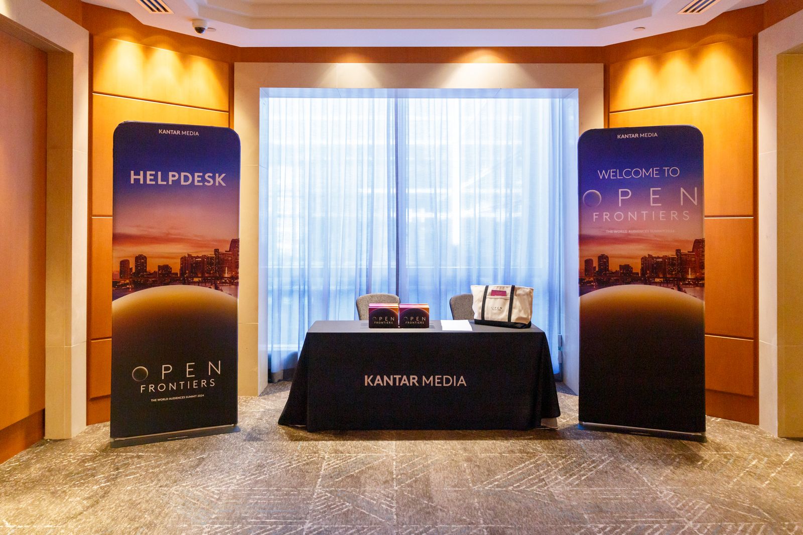Branded help desk with event banners in a hotel foyer
