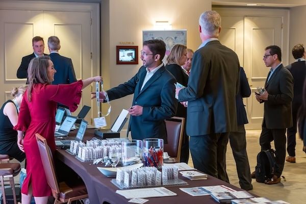 Attendees picking up badges at a registration desk