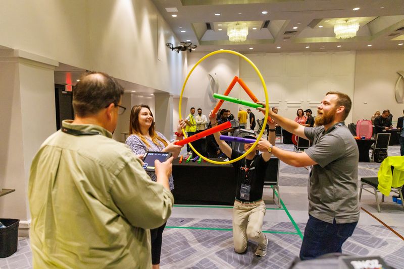 Attendees playing a team hoop game during a sales kickoff