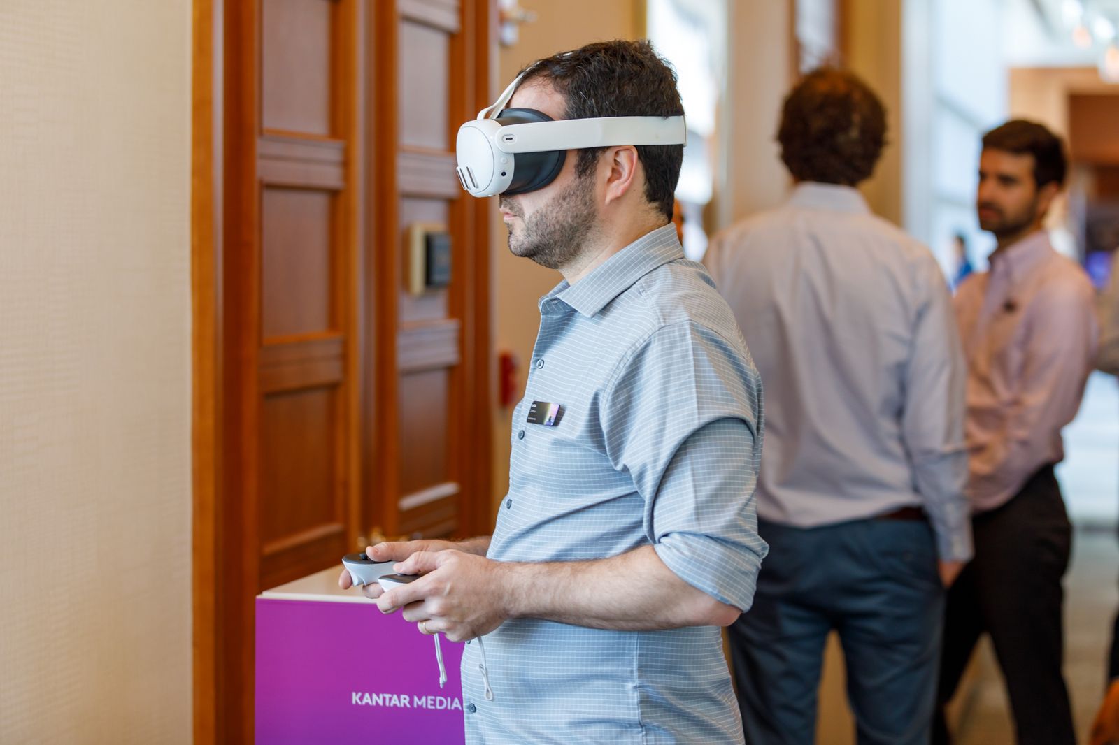 Attendee trying a VR headset demo at an exhibitor table